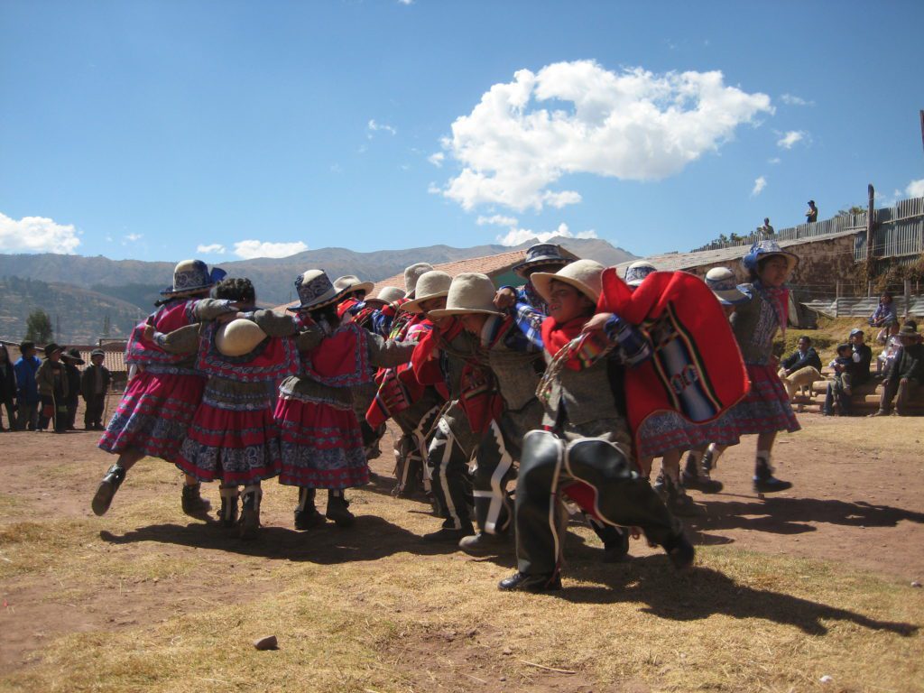 elementary students in Peru giving a colorful performance