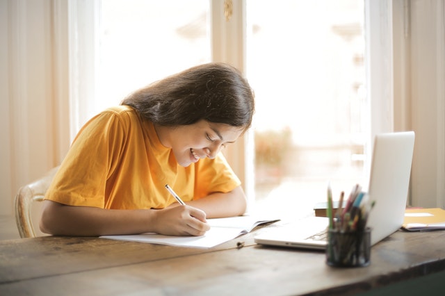 Student happily working at a desk